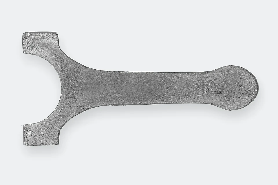 Sectioned and etched forged connecting rod showing the grain-flow pattern